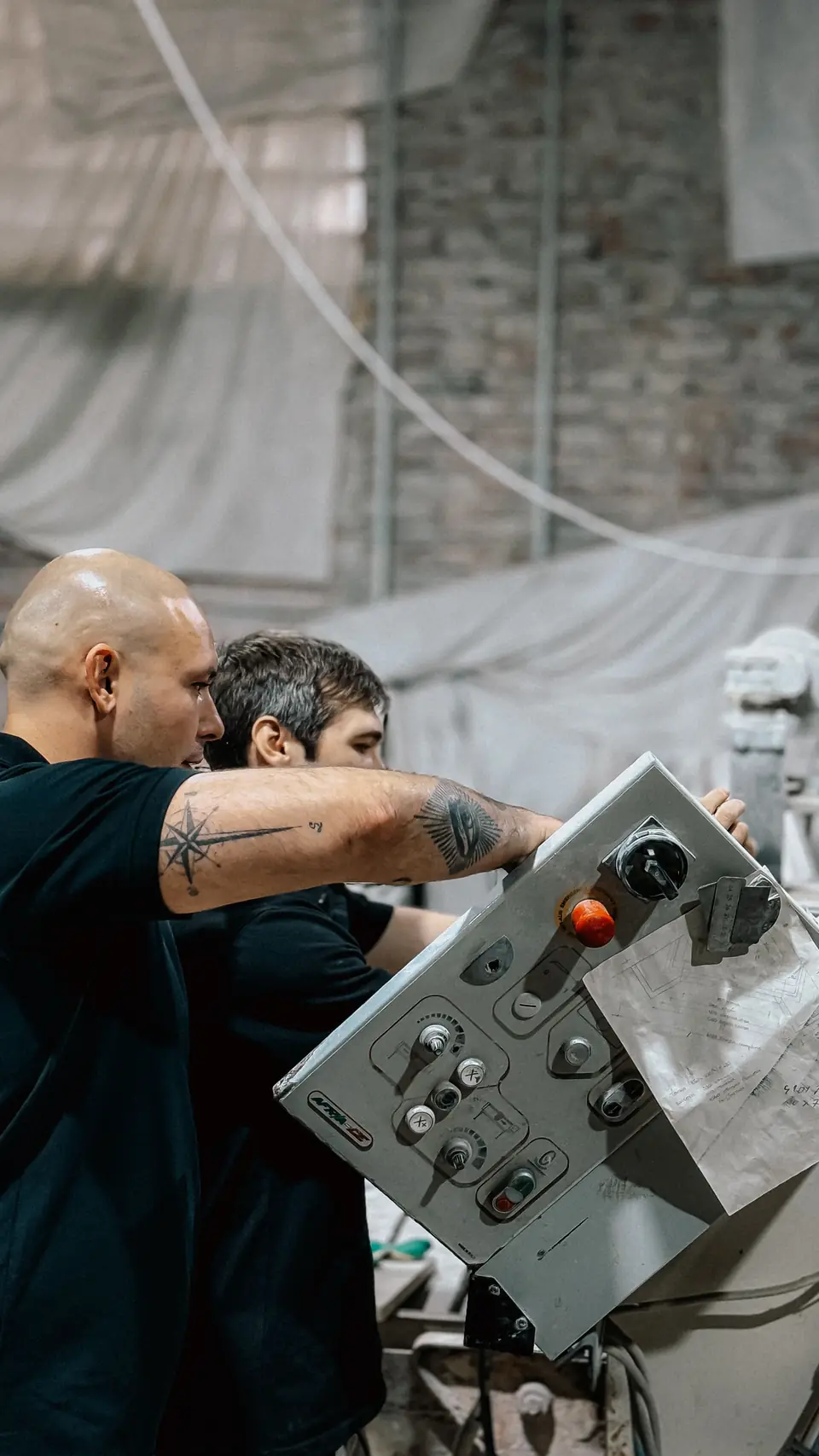 Technicians working on an industrial panel