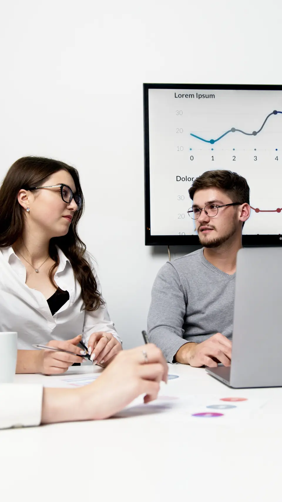 Two colleagues reviewing KPIs in the office