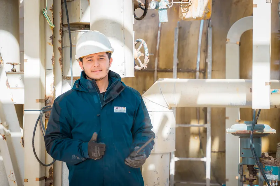 Plant operator with hard hat and protective gear