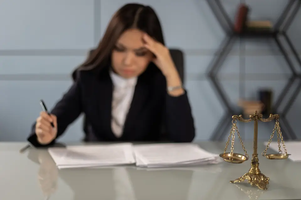 Professional under work stress reviewing documents