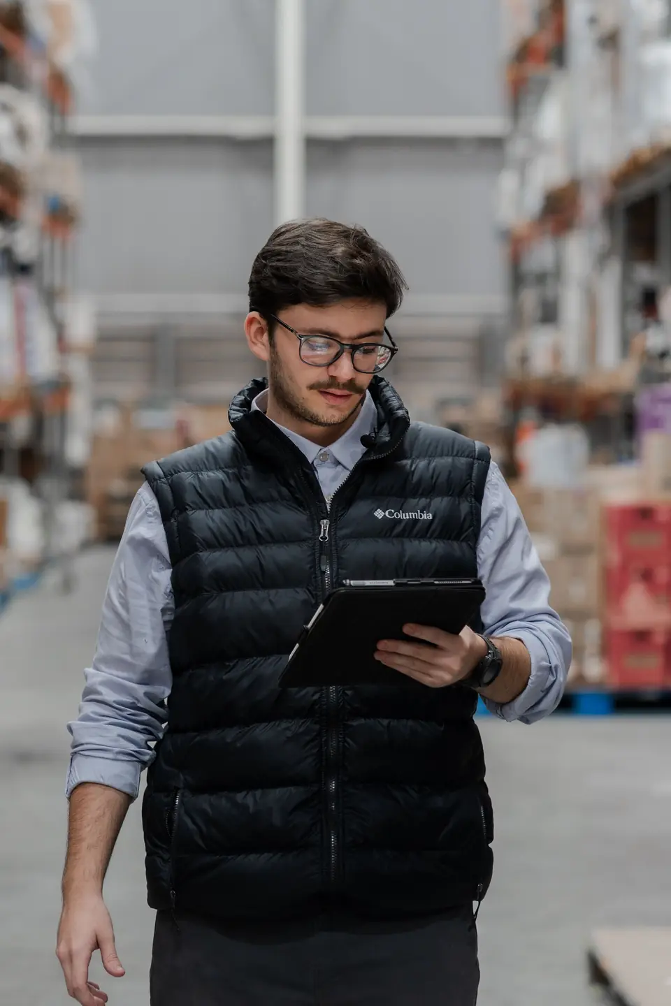 Warehouse supervisor checking data on a tablet