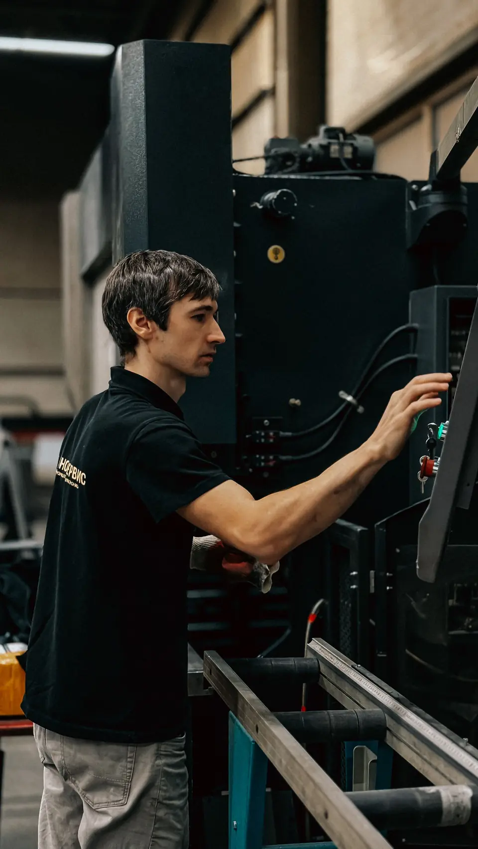 Operator adjusting a machine on the plant floor